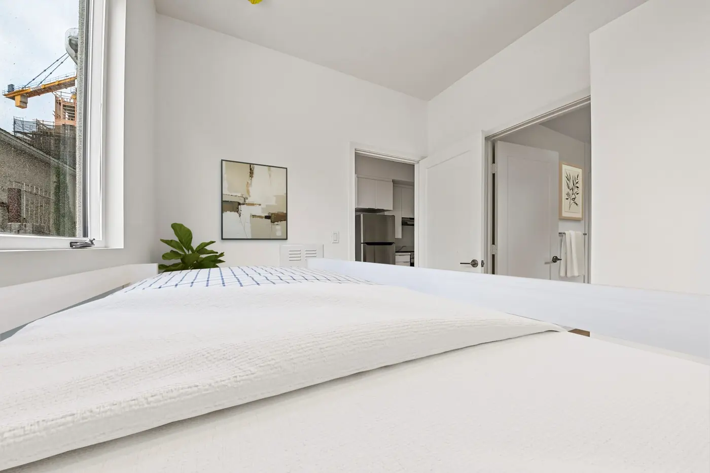 Bedroom with plank flooring and window coverings
