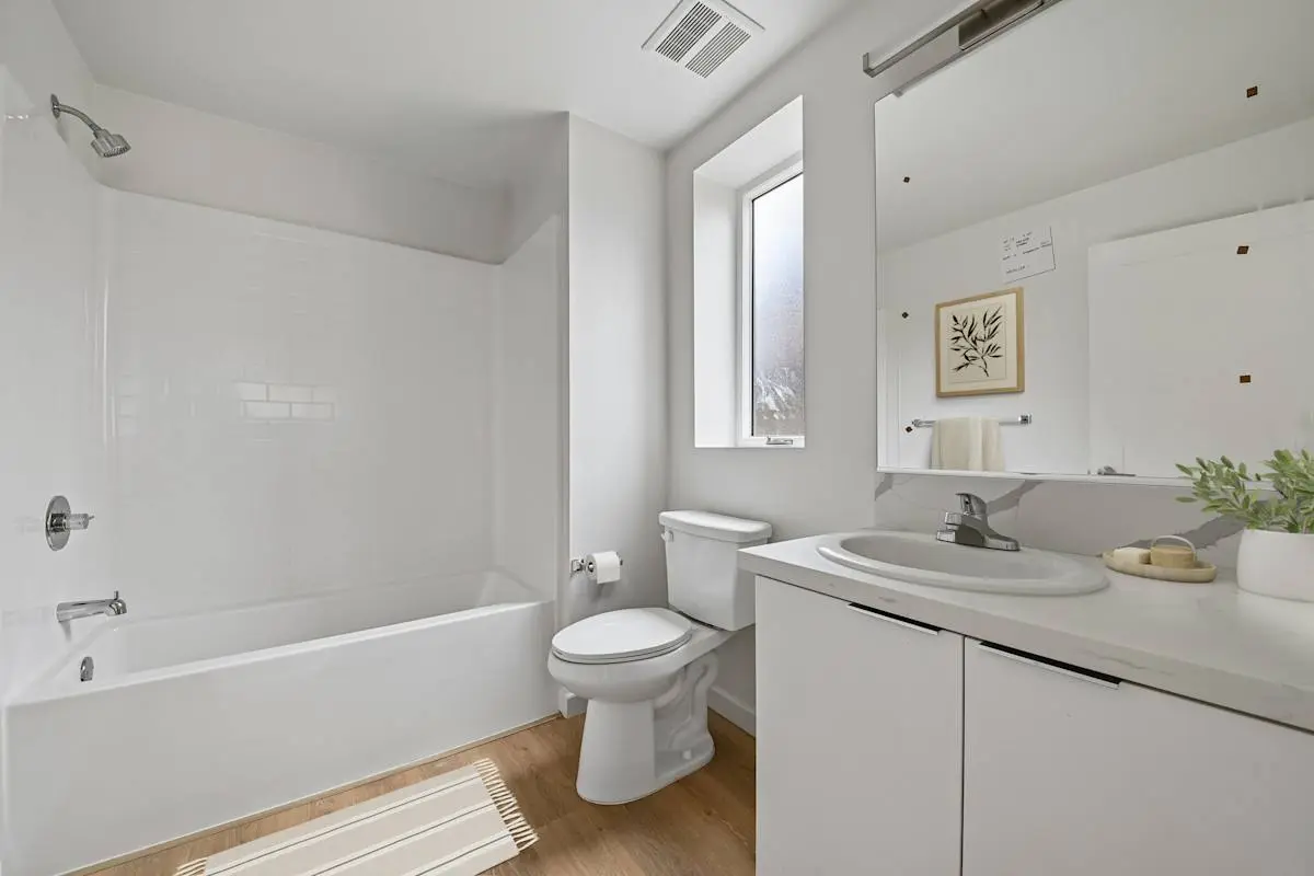 Bathroom with vanity, toilet, and tub