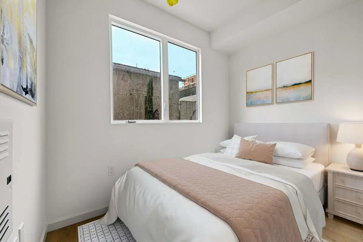 Bedroom with large bed and city views through the window