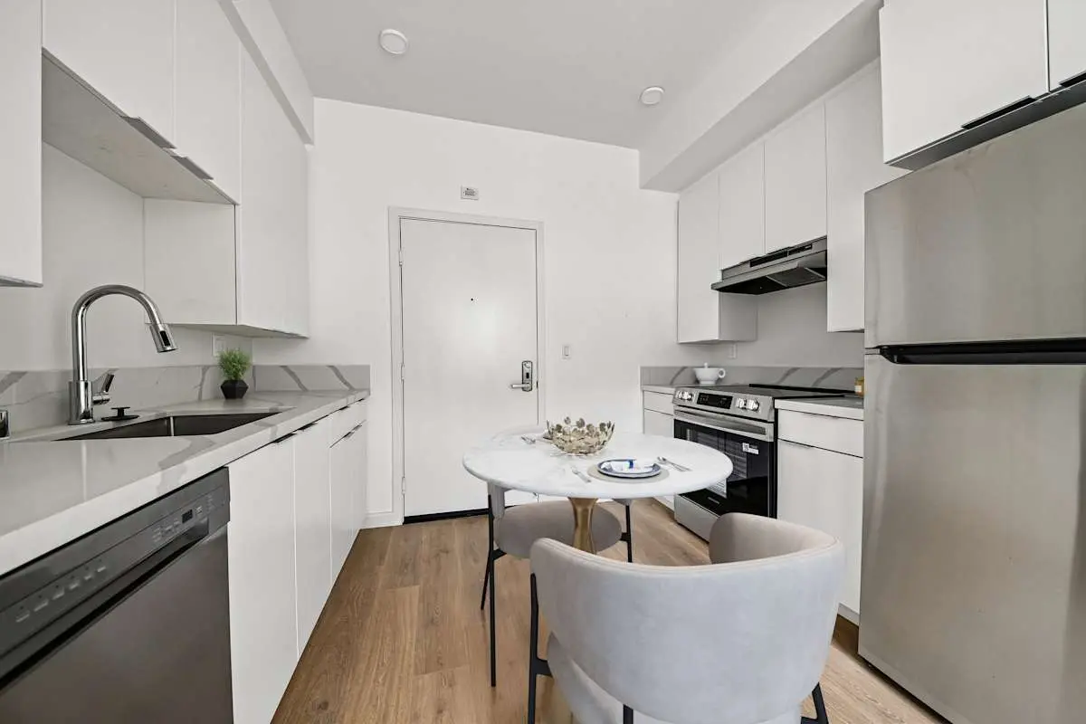 Kitchen with stainless appliances and dining seating